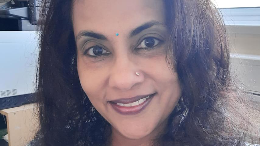 Writer in Residence and Author Radhika Iyer. Radhika has long, dark hair, framing her face and a turquoise bindi on her forehead.