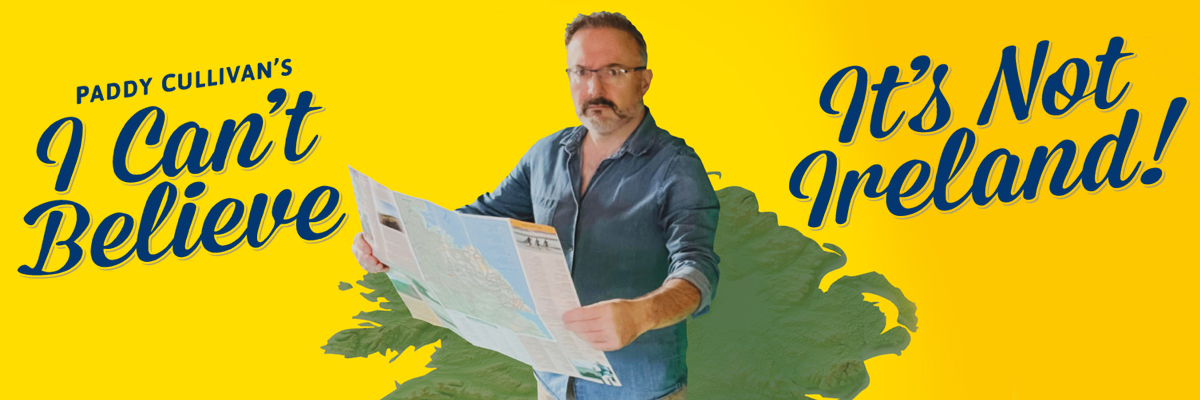 A man with glasses and a beard, holding a map, stands on a map representation of Ireland with yellow background